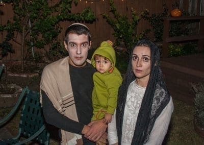 Two adults and a baby dressed up in Halloween costumes
