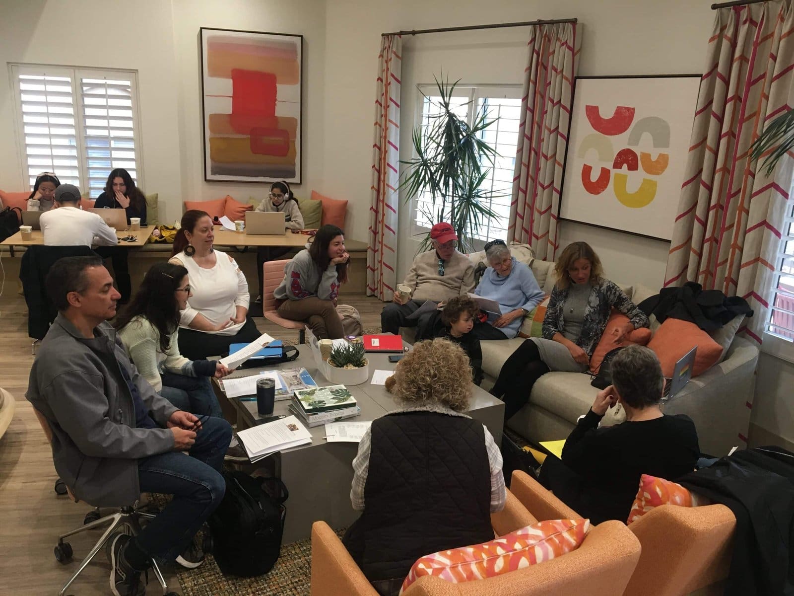 A group of people sitting around a table chatting