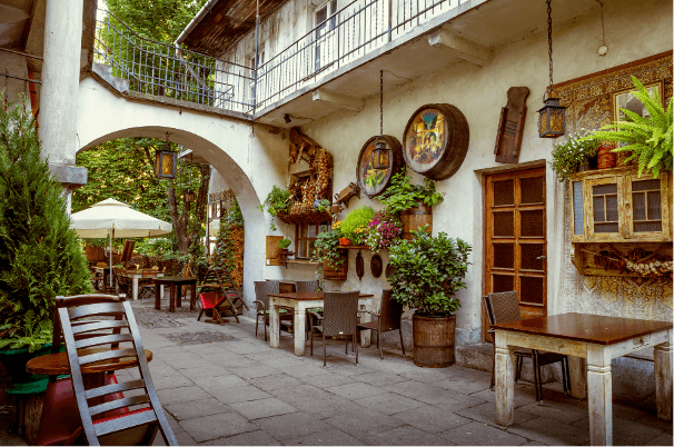Poland2 A photograph of a courtyard restaurant with artwork and furniture