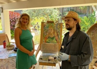Oleg Tsank holding his sketchbook and smiling during a Yiddish portrait session at Yiddishland California.